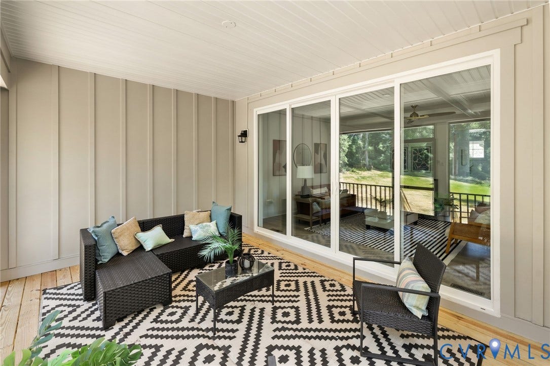 12506 Ashton Dell Road, Chester, VA 23831 Covered porch with wood-finish flooring, vertical paneling, and a horizontal panel ceiling