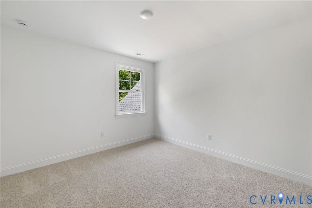 12506 Ashton Dell Road, Chester, VA 23831 White walls, neutral carpet, and a single window with white trim
