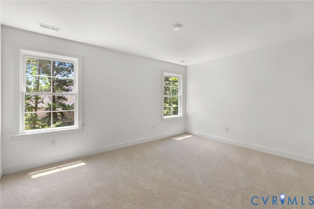 12506 Ashton Dell Road, Chester, VA 23831 Carpeted room with two multi-pane windows and white walls