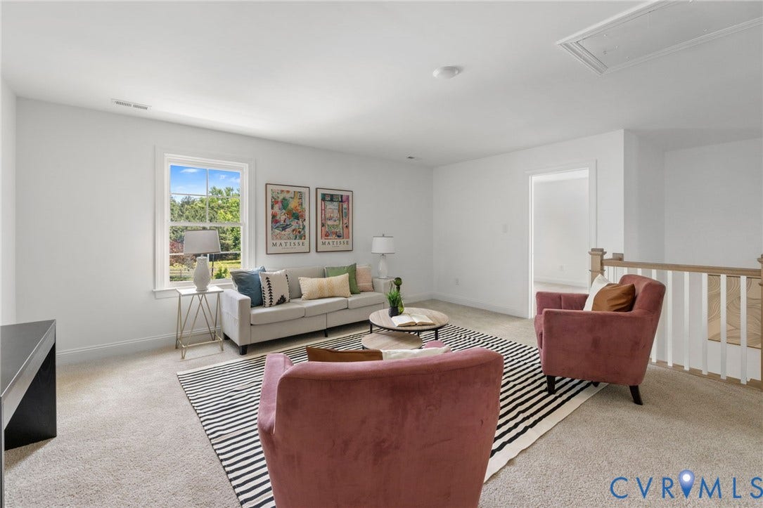 12506 Ashton Dell Road, Chester, VA 23831 Carpeted upper-level space featuring a window, painted white walls, and a wooden railing with white balusters