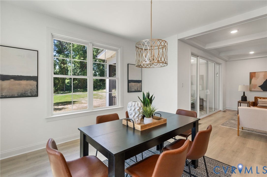 12506 Ashton Dell Road, Chester, VA 23831 Open-concept living space featuring wood-finish flooring, a contemporary chandelier, and a large window