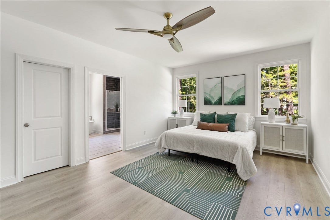 12506 Ashton Dell Road, Chester, VA 23831 Light-filled bedroom featuring wood-finish flooring, two large windows, a ceiling fan, and a paneled door