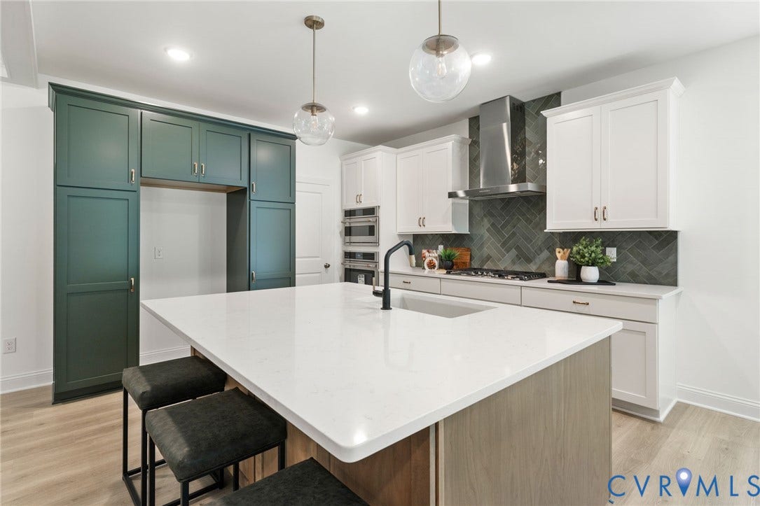 12506 Ashton Dell Road, Chester, VA 23831 Kitchen featuring a large central island with a white countertop, two-tone cabinetry, a herringbone tile backsplash, and stainless steel appliances