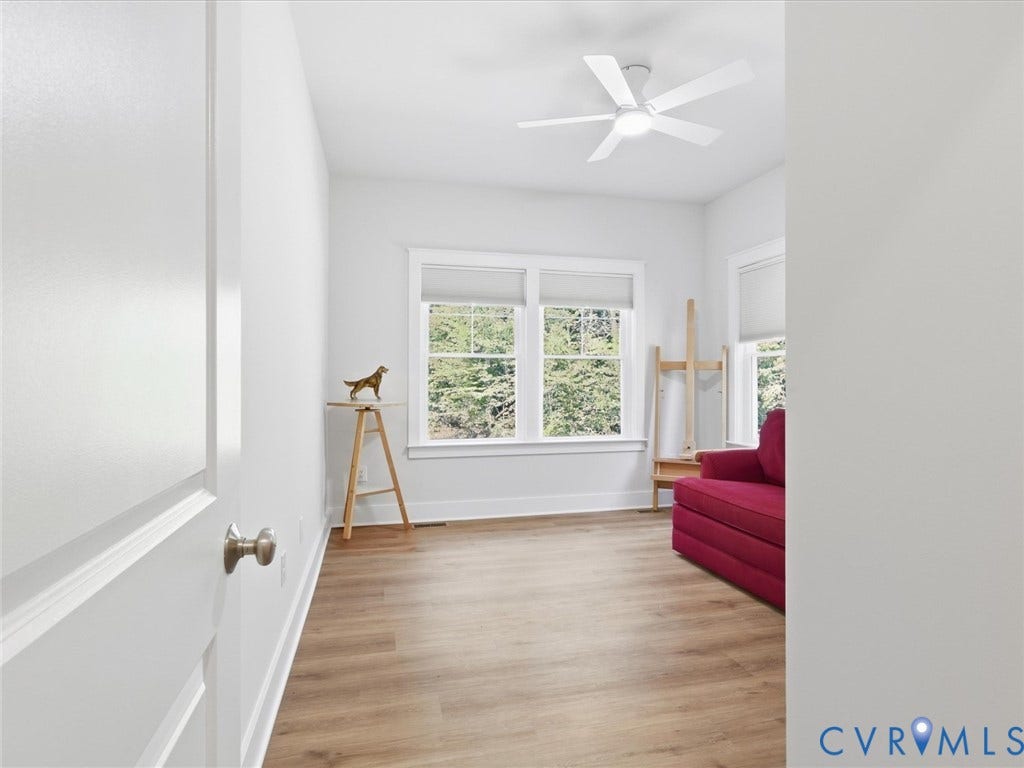3102 Kensington Lane, Goochland, VA 23063 Expansive room featuring wood-finish flooring, multiple windows, a ceiling fan, and white trim throughout