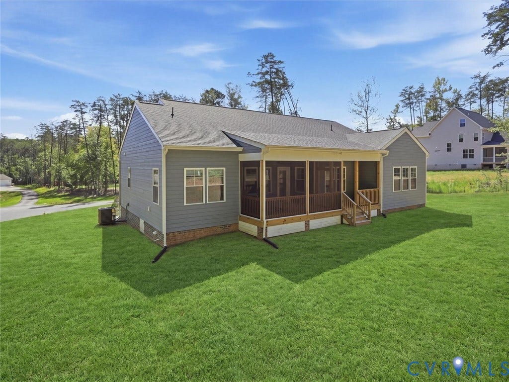 3102 Kensington Lane, Goochland, VA 23063 Exterior featuring blue siding, a screened porch with wood railings, a gabled roof, and a verdant lawn