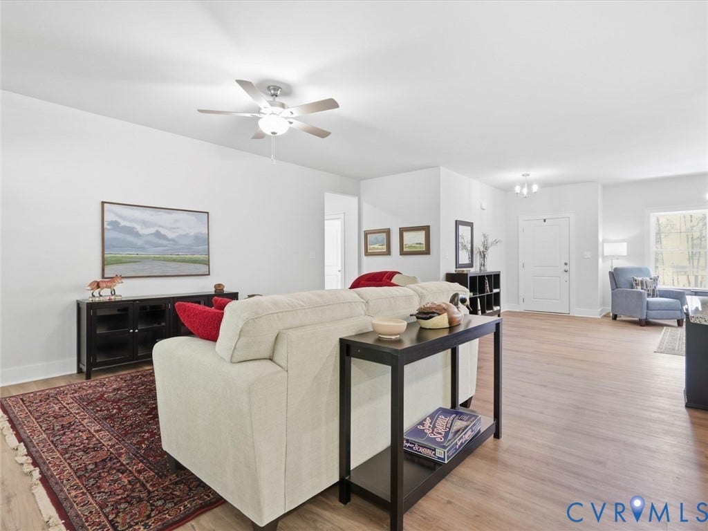 3102 Kensington Lane, Goochland, VA 23063 Expansive room with wood-finish flooring, white walls, ceiling fan with integrated lighting, and recessed lighting