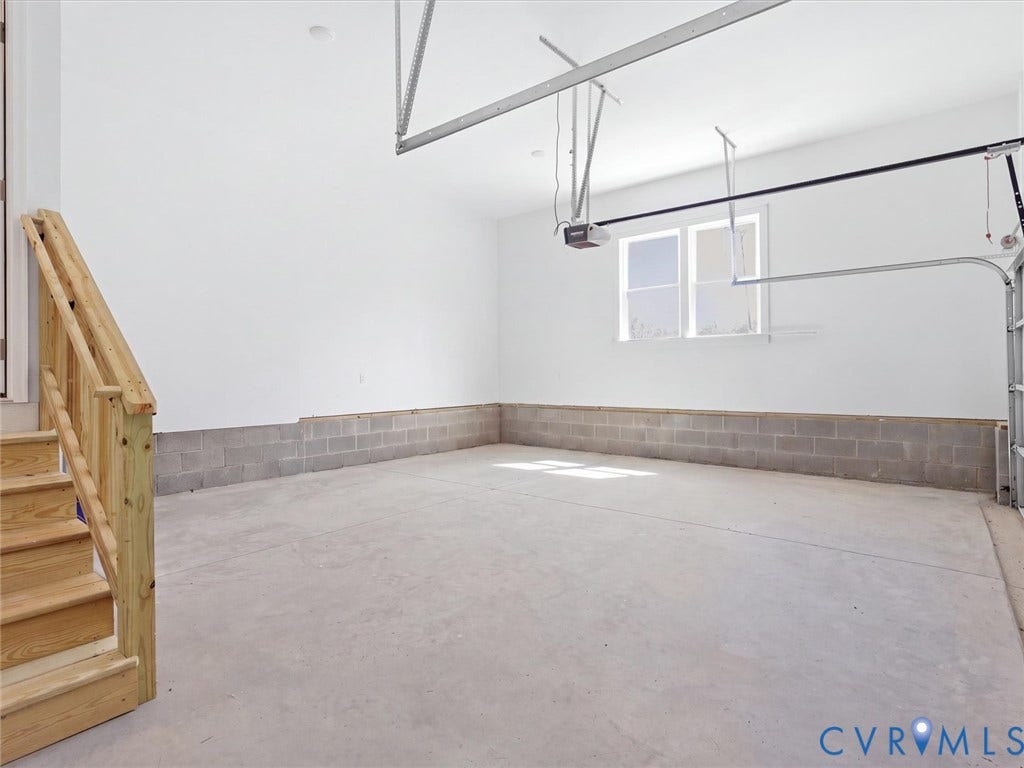 3102 Kensington Lane, Goochland, VA 23063 Spacious garage featuring a concrete floor, light-colored walls, and a window