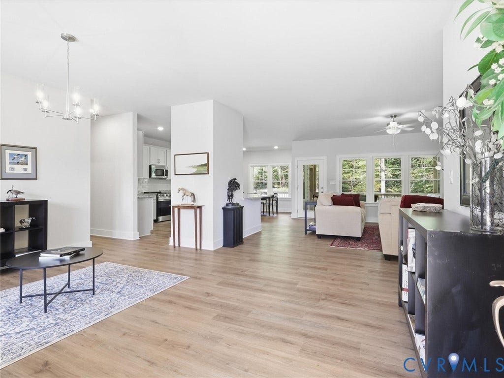 3102 Kensington Lane, Goochland, VA 23063 Open-concept living space featuring wood-finish flooring, recessed lighting, and a contemporary chandelier