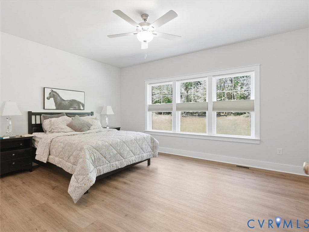 3102 Kensington Lane, Goochland, VA 23063 Wood-finish flooring, white walls, triple window unit, ceiling fan with light fixture