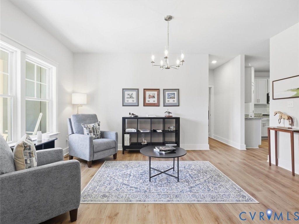3102 Kensington Lane, Goochland, VA 23063 Bright living space featuring wood-finish flooring, white walls, and a contemporary chandelier