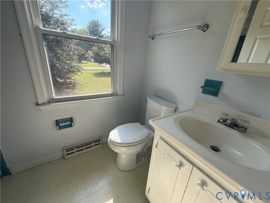 4512 Greenbriar Drive, Chester, VA 23831 Bathroom featuring a single-pane window, square tile flooring, white vanity with integrated sink, and a chrome faucet