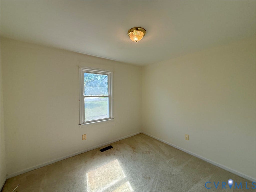4512 Greenbriar Drive, Chester, VA 23831 Interior room with neutral wall paint, a double-hung window, and a ceiling-mounted light fixture
