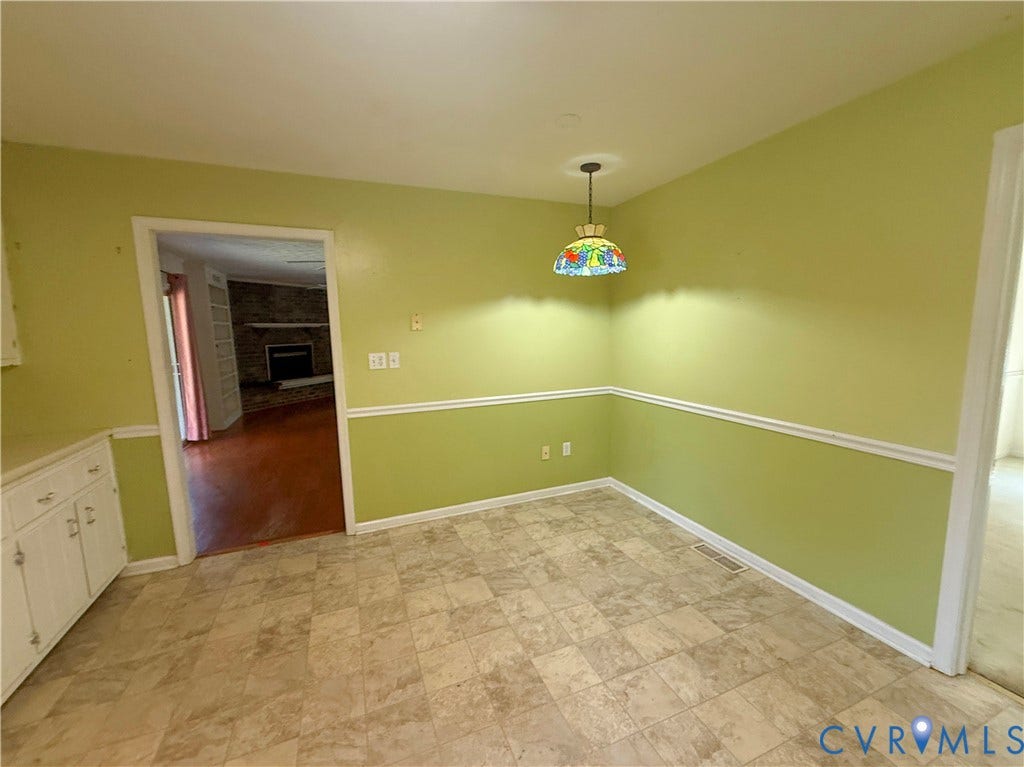 4512 Greenbriar Drive, Chester, VA 23831 Built-in cabinetry with white panel doors, vinyl tile flooring, and a decorative ceiling light fixture
