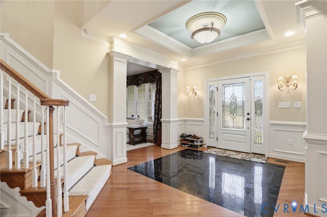 Hardwood flooring, decorative trim, recessed lighting, coffered ceiling, and transom window with sidelights