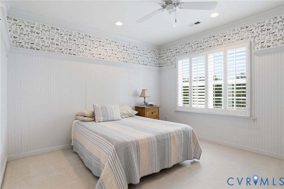 White beadboard wainscoting, decorative wallpaper border, recessed lighting, ceiling fan, and window with plantation shutters