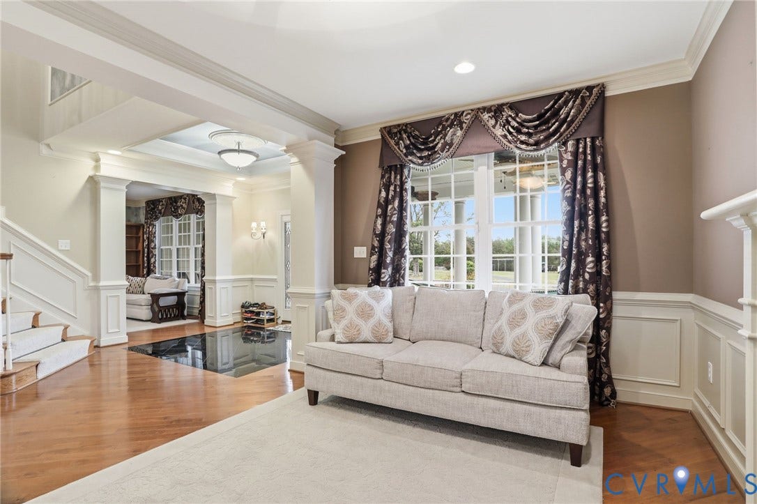 Hardwood flooring, white wainscoting, crown molding, double hung windows, and recessed lighting