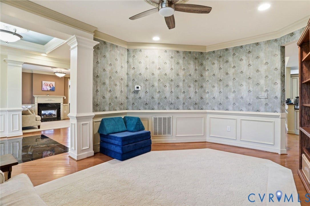 Recessed lighting, ceiling fan, decorative wallpaper, wainscoting, and wood-finish flooring