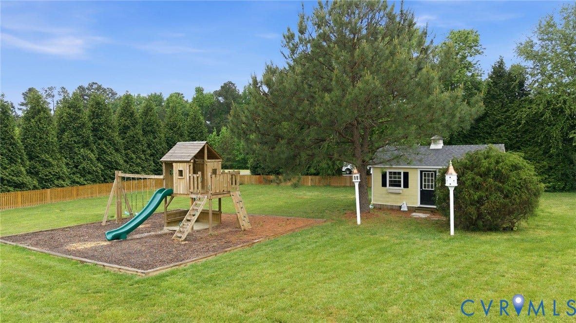Expansive manicured lawn with a wooden privacy fence