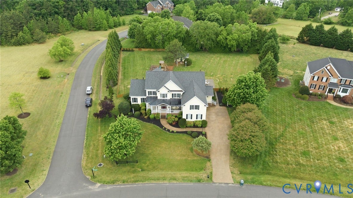 Two-story residence with a gray shingle roof, white siding, and dark shutters