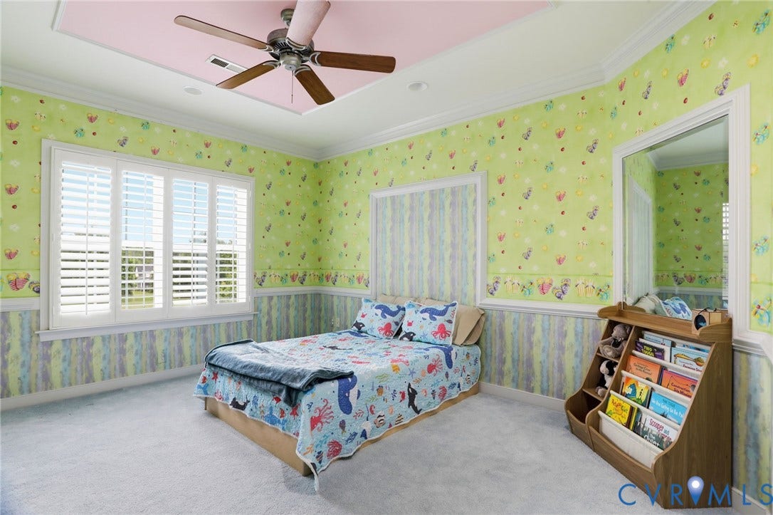 Recessed ceiling with a flush-mounted ceiling fan, white crown molding, and white window shutters