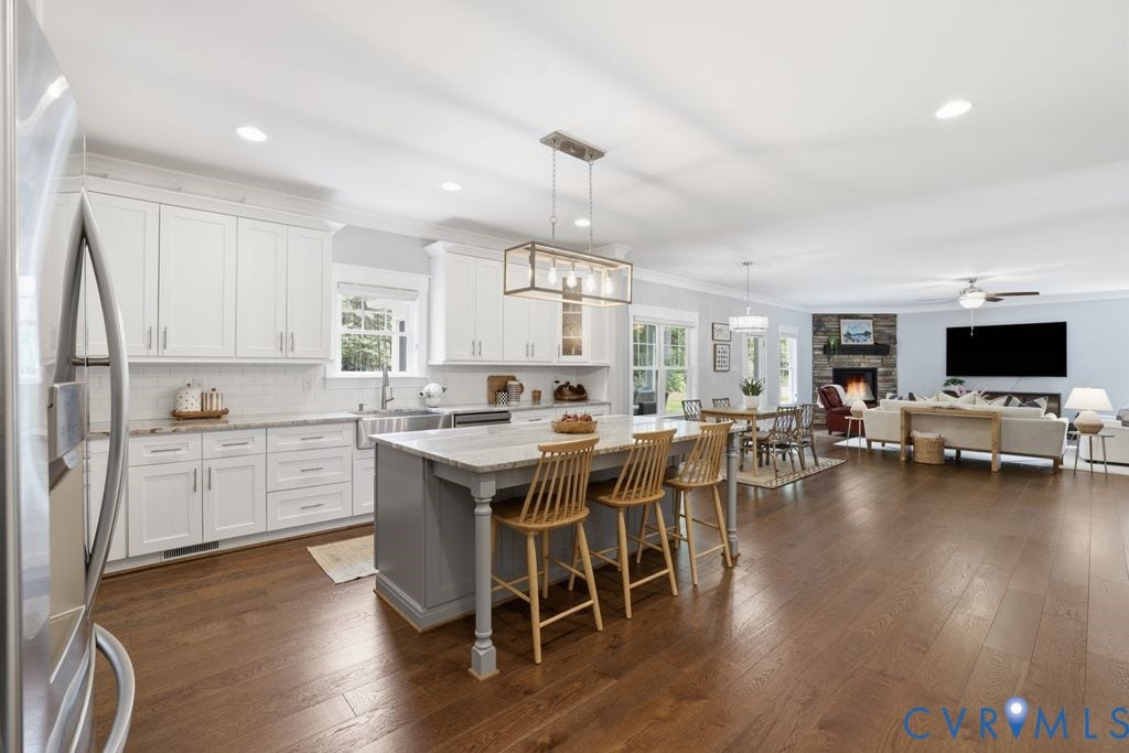 13114 Spring Road, Barr Brook Farms, Rockville, VA 23146 Open-concept living area with wood-finish flooring, white cabinetry, a stone-faced fireplace, and recessed lighting