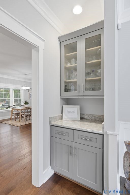 13114 Spring Road, Barr Brook Farms, Rockville, VA 23146 Built-in cabinetry with glass-front upper doors, wood-finish flooring, and a stone countertop