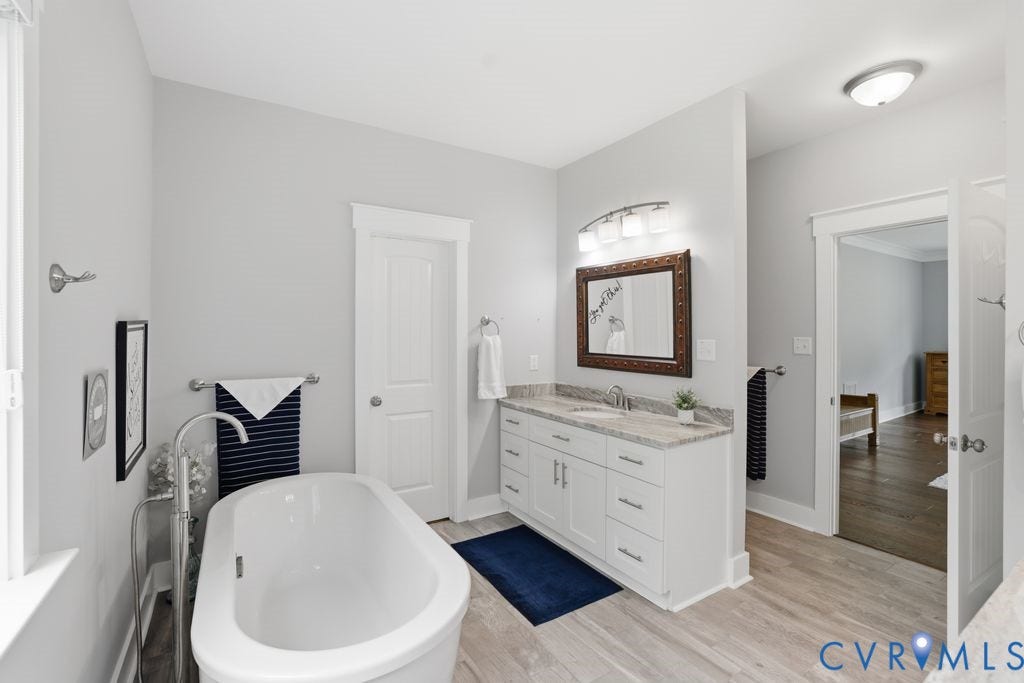 13114 Spring Road, Barr Brook Farms, Rockville, VA 23146 Freestanding soaking tub, double vanity with stone countertop, chrome fixtures, and wood-finish flooring