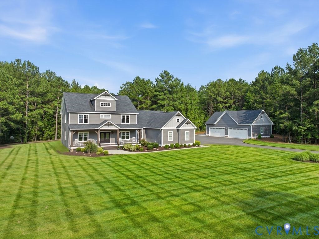 13114 Spring Road, Barr Brook Farms, Rockville, VA 23146 Expansive lawn with pattern mowing, a two-story gray exterior, covered front porch, and an additional detached three-car garage