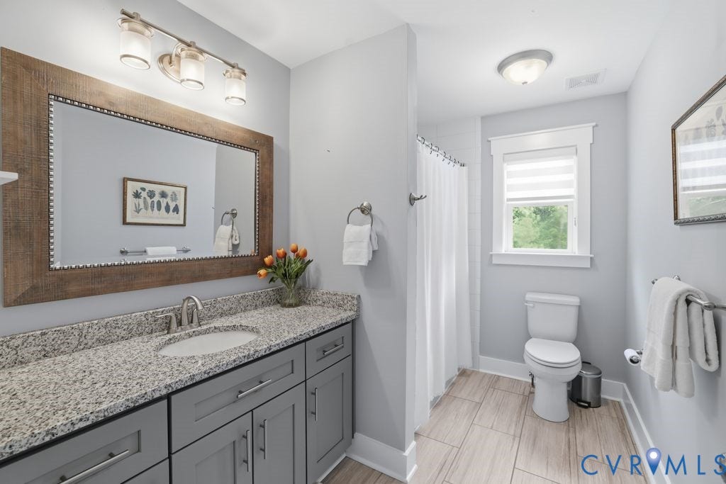 13114 Spring Road, Barr Brook Farms, Rockville, VA 23146 Granite-finish countertop with an undermount sink, gray cabinetry, and a large framed mirror with integrated lighting