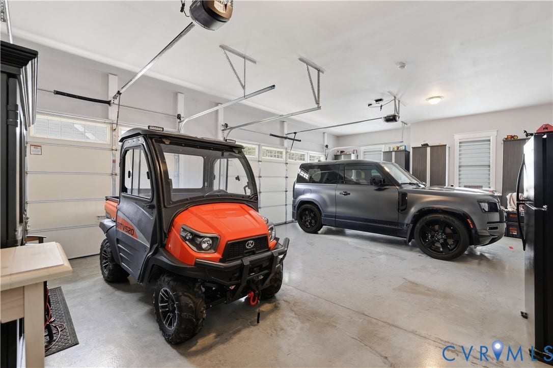 13114 Spring Road, Barr Brook Farms, Rockville, VA 23146 Three-car garage featuring automatic openers, transom windows, and built-in storage cabinetry