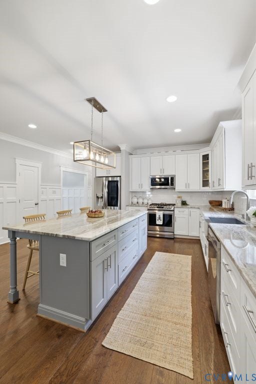 13114 Spring Road, Barr Brook Farms, Rockville, VA 23146 Kitchen featuring wood-finish flooring, white upper and lower cabinetry, stainless steel appliances, a large center island with a stone countertop, and recessed lighting