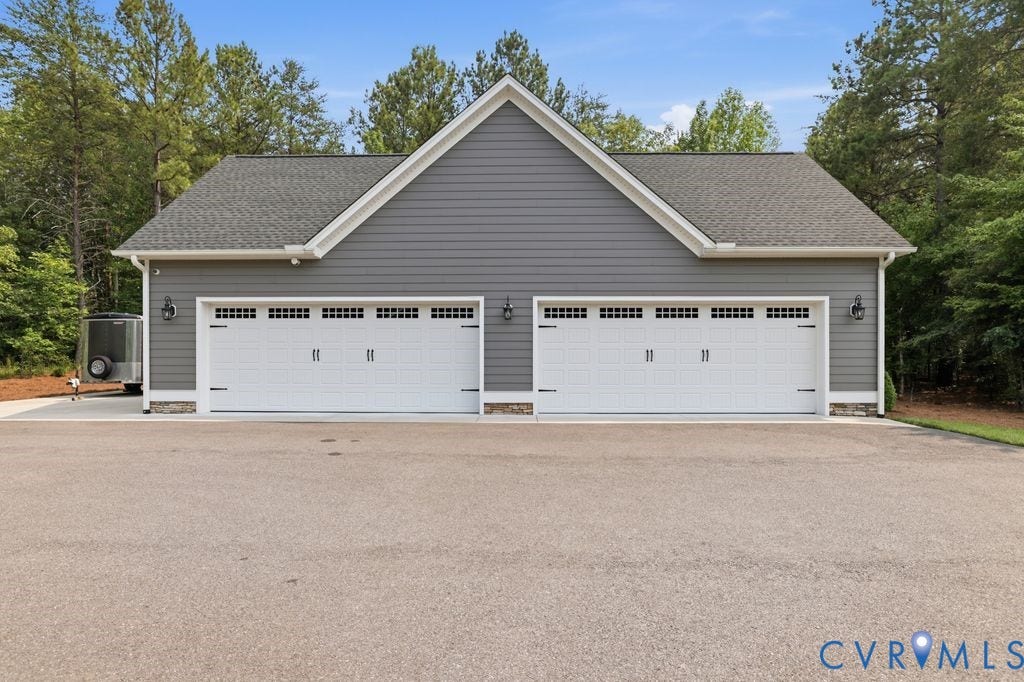 13114 Spring Road, Barr Brook Farms, Rockville, VA 23146 Two-car garage with white paneled doors, decorative hardware, and integrated window accents