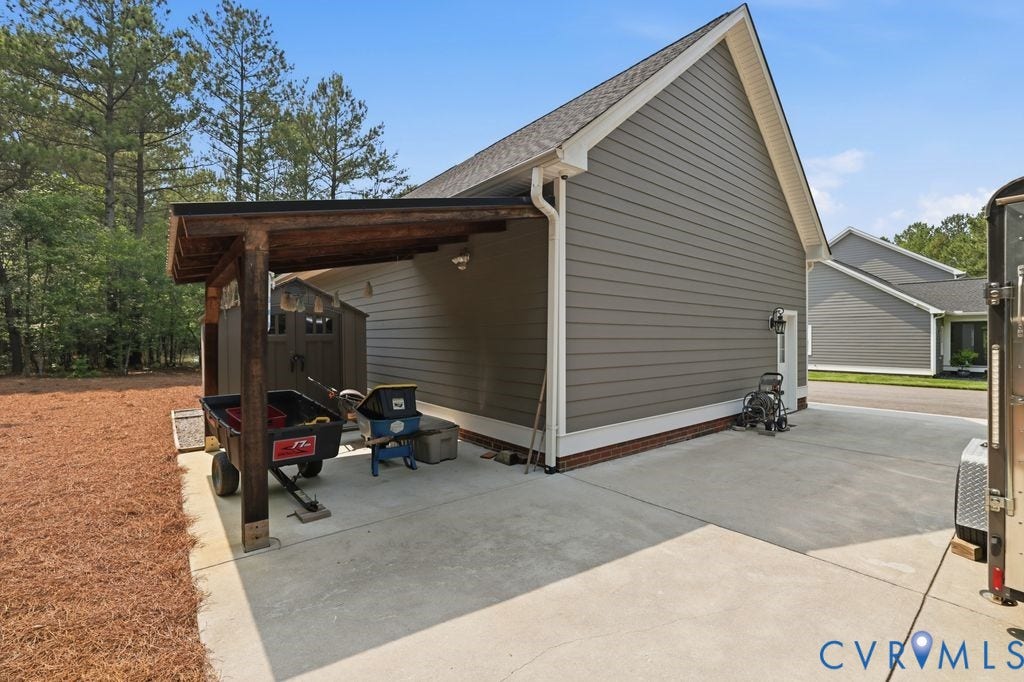 13114 Spring Road, Barr Brook Farms, Rockville, VA 23146 Gable roofline with horizontal siding, concrete paving, and a wood-frame lean-to structure