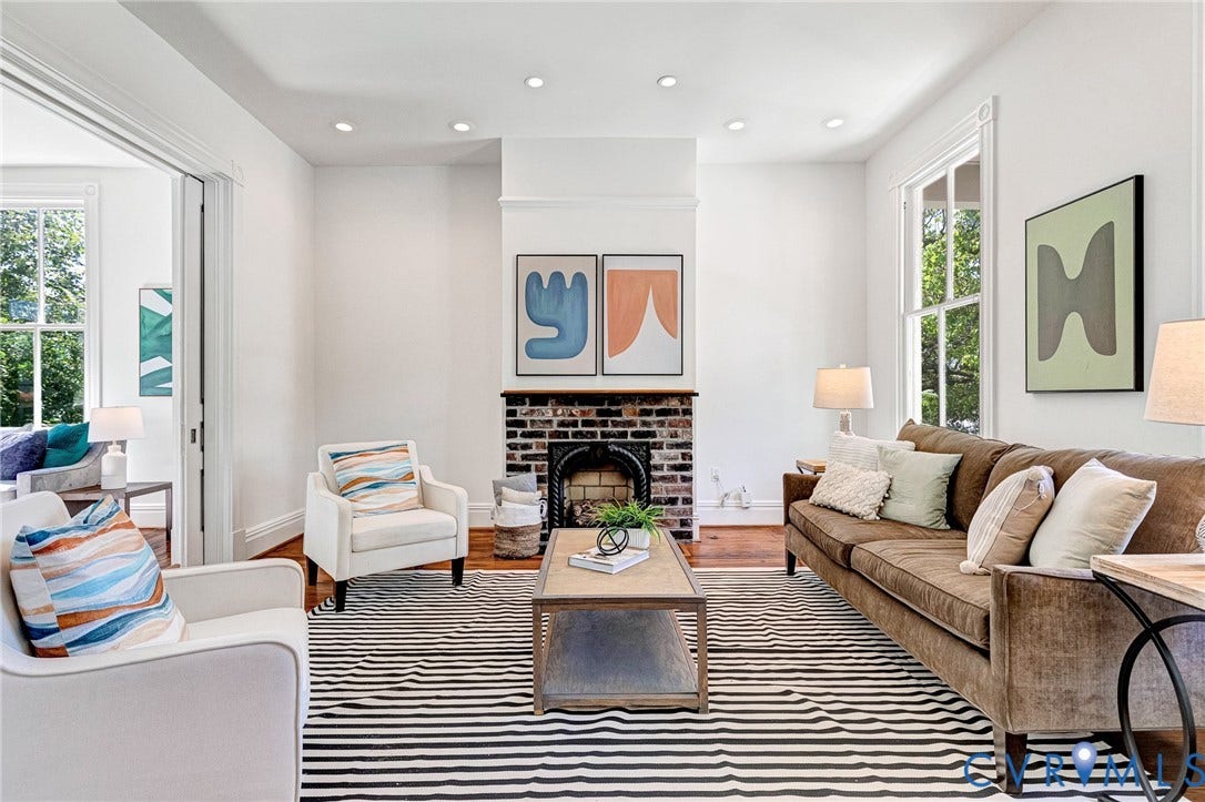 615 N 23rd Street, Church Hill Central, Richmond, VA 23223 Hardwood flooring, recessed lighting, brick fireplace with metal insert, white trim, and multiple windows