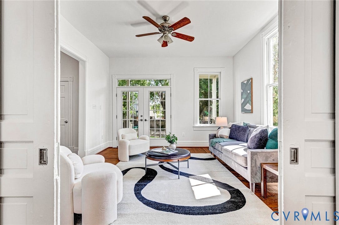 615 N 23rd Street, Church Hill Central, Richmond, VA 23223 Pocket door entry to a bright living area featuring hardwood flooring, a ceiling fan, and double French doors opening to the exterior