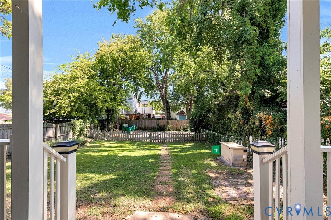 615 N 23rd Street, Church Hill Central, Richmond, VA 23223 Expansive grassy yard area with a picket fence boundary and mature trees