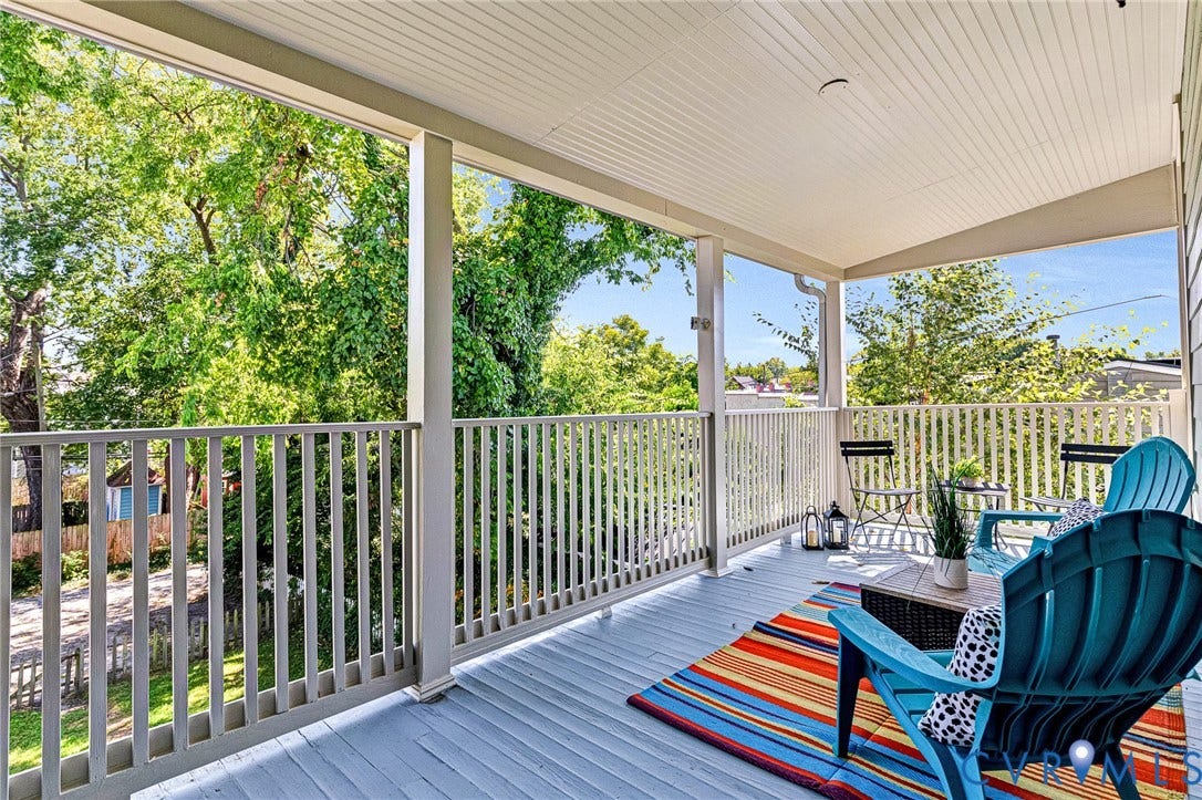 615 N 23rd Street, Church Hill Central, Richmond, VA 23223 Covered outdoor balcony with wood-finish flooring and a white slatted railing