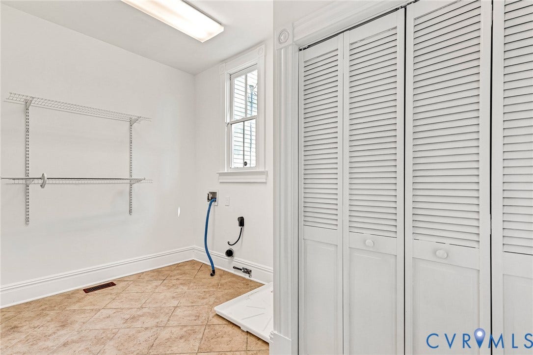 615 N 23rd Street, Church Hill Central, Richmond, VA 23223 Louvered bi-fold doors, tiled flooring, wire shelving, and a window with white trim