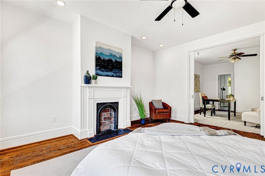 615 N 23rd Street, Church Hill Central, Richmond, VA 23223 Hardwood flooring throughout, recessed lighting, ceiling fan, decorative fireplace with ornate cast iron insert, and pocket doors leading to an adjoining room