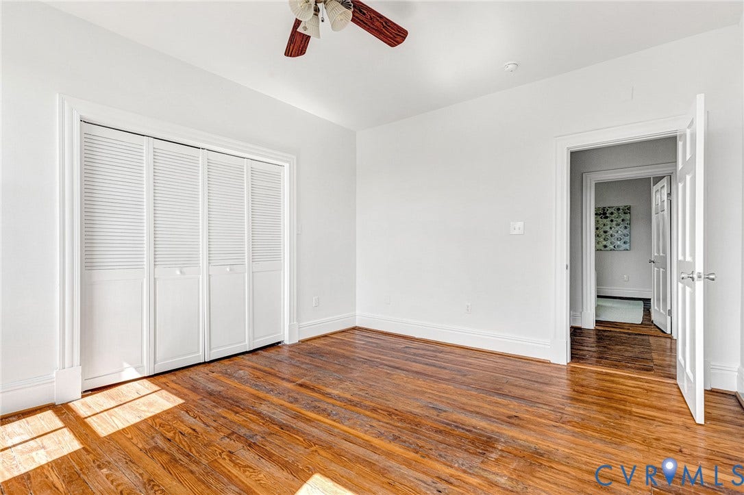 615 N 23rd Street, Church Hill Central, Richmond, VA 23223 Hardwood flooring, painted walls, white trim, bi-fold louvered closet doors, and a ceiling fan