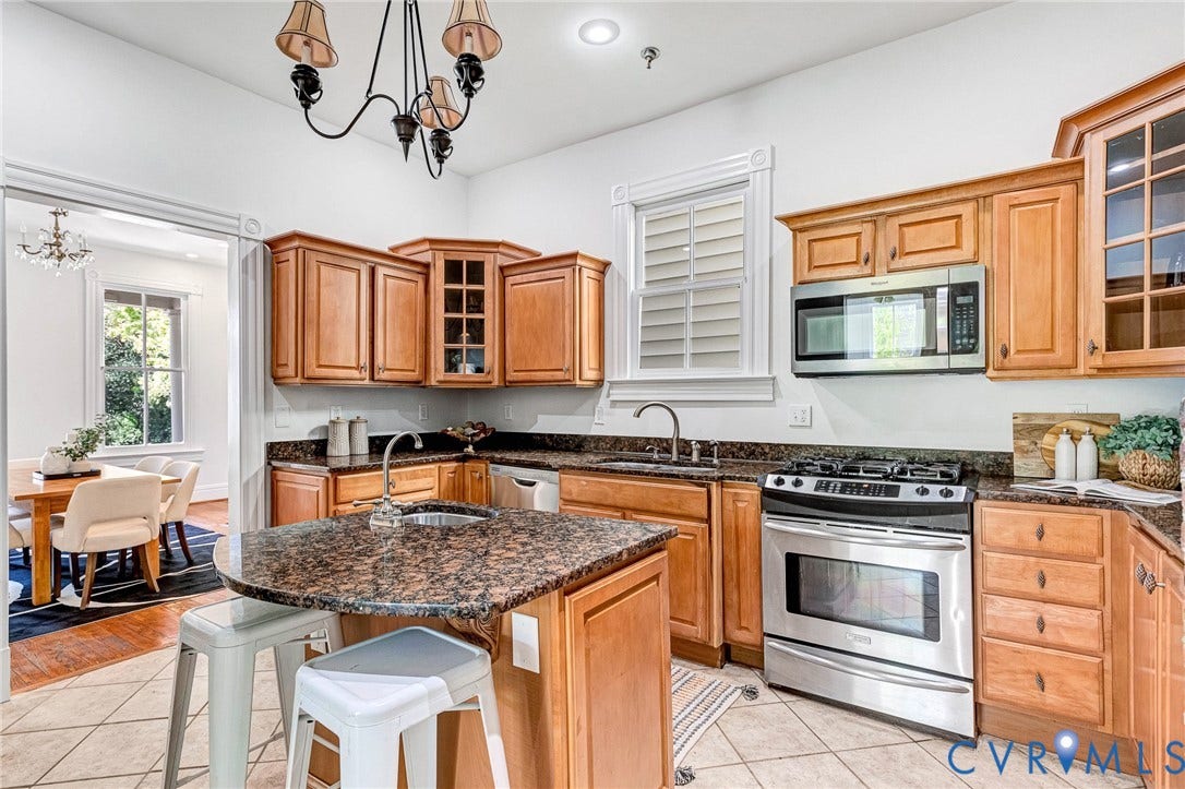 615 N 23rd Street, Church Hill Central, Richmond, VA 23223 Kitchen featuring wood cabinetry, dark speckled countertops, a stainless steel range, and a built-in microwave