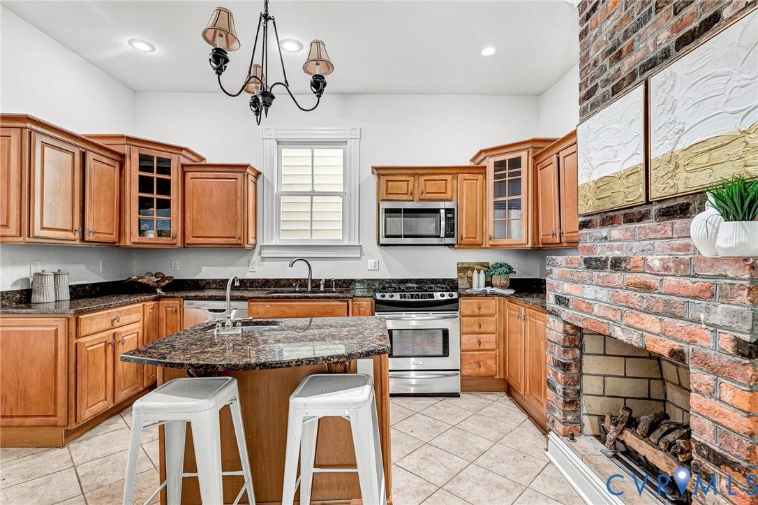 615 N 23rd Street, Church Hill Central, Richmond, VA 23223 Full kitchen with wood cabinetry, stainless steel appliances, and a central island
