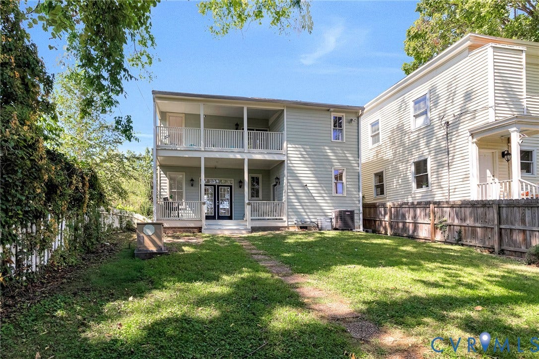 615 N 23rd Street, Church Hill Central, Richmond, VA 23223 Exterior featuring a two-story porch with white railings, double French doors, and exterior wall sconces