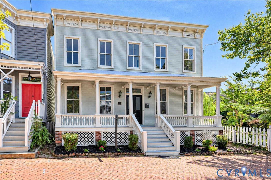 615 N 23rd Street, Church Hill Central, Richmond, VA 23223 Historic-style facade with a full-width covered porch, white picket fence, and brick paver driveway
