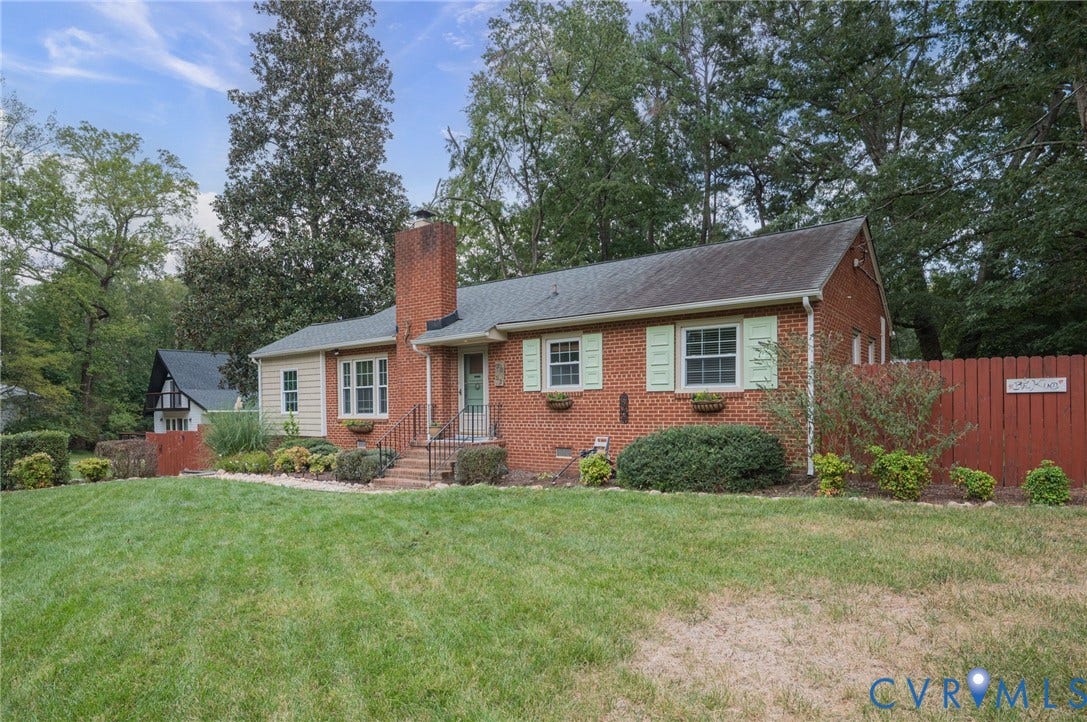 3353 Warner Road, Stratford Hills, Richmond, VA 23225 Brick exterior with a prominent chimney, light green shutters, and a front entry with handrails