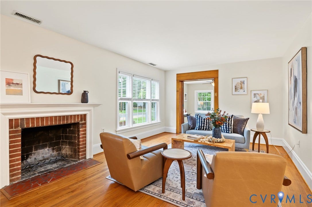 3353 Warner Road, Stratford Hills, Richmond, VA 23225 Brick fireplace with a white mantel, wood-finish flooring, white window blinds, and a wood-trimmed doorway