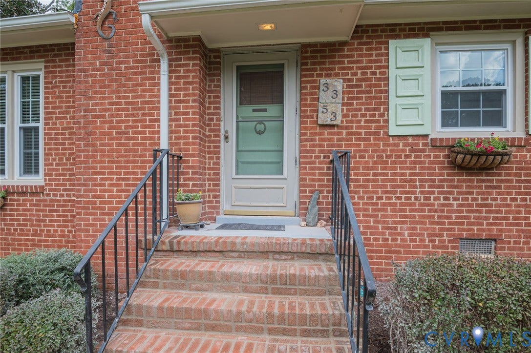 3353 Warner Road, Stratford Hills, Richmond, VA 23225 Brick exterior with white trim, green shutters, and a front entry door with a screen door