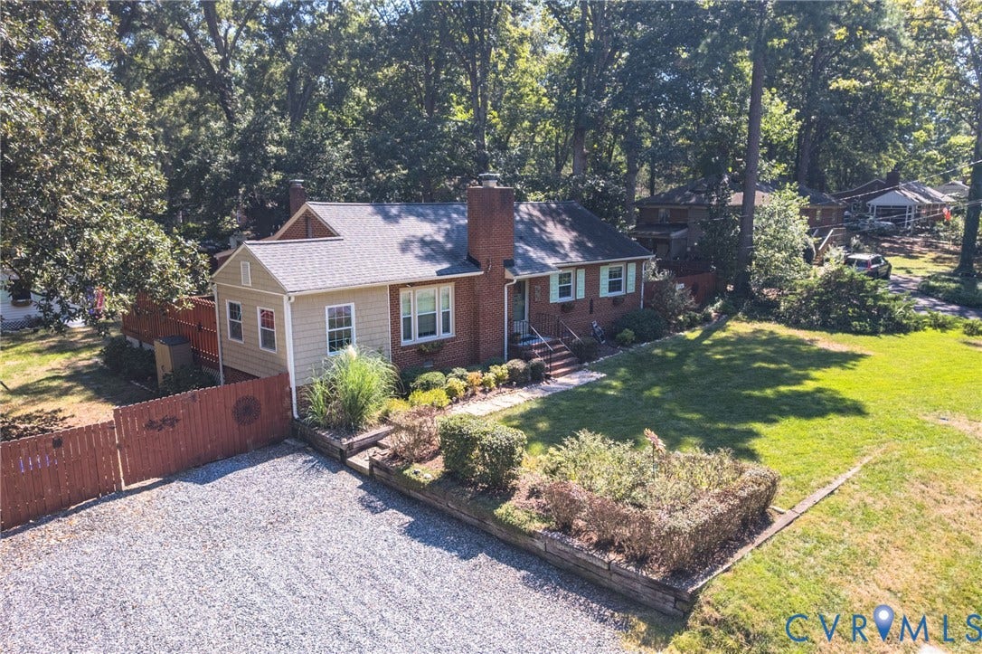 3353 Warner Road, Stratford Hills, Richmond, VA 23225 Brick and siding exterior with a shingled roof, gravel driveway, and mature landscaping