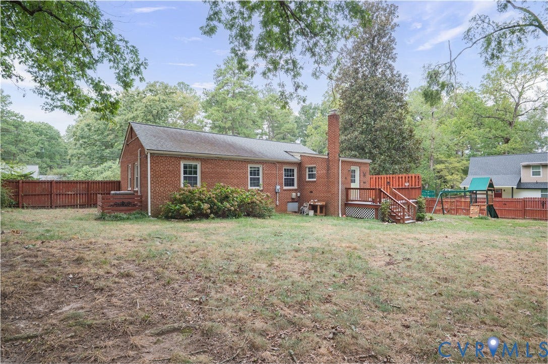 3353 Warner Road, Stratford Hills, Richmond, VA 23225 Brick exterior with a prominent chimney, wood deck, and wood privacy fencing
