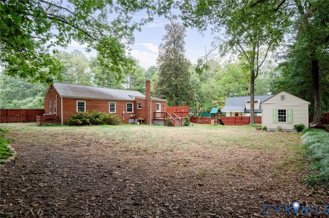 3353 Warner Road, Stratford Hills, Richmond, VA 23225 Brick exterior with a prominent chimney, wood deck, and detached storage shed